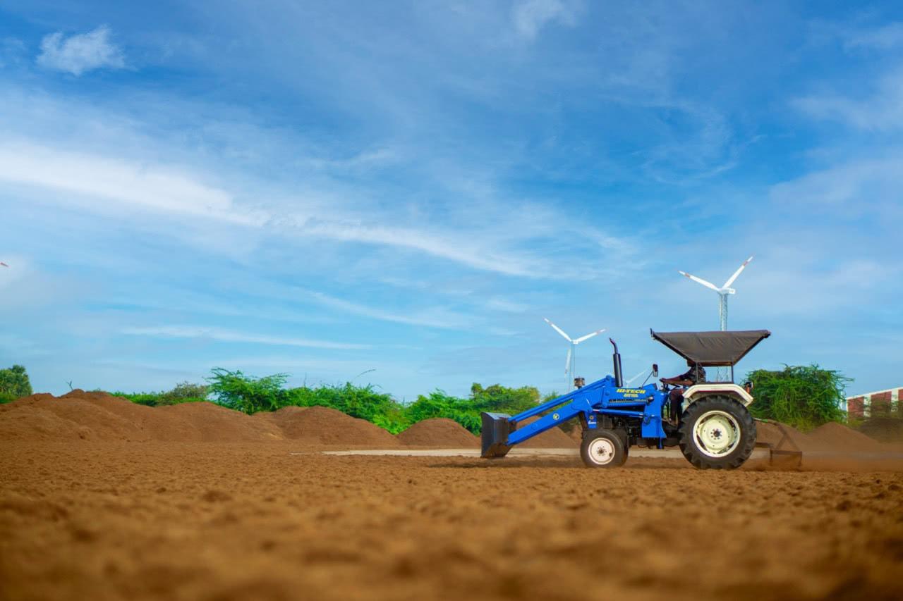 Wind turbines and machinery on the Balterra sourcing farmland